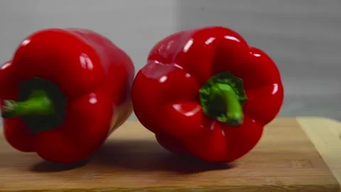Bell pepper falls on a bamboo cutting board Stock Footage 195523948