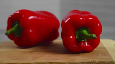 Bell pepper falls on a bamboo cutting board Stock Footage 195523950