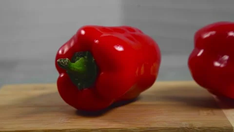 Bell pepper falls on a bamboo cutting board Stock Footage 195523951