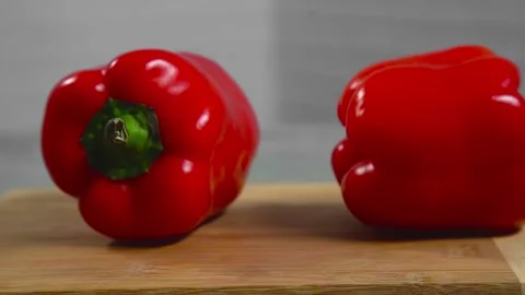 Bell pepper falls on a bamboo cutting board Stock Footage 195523964
