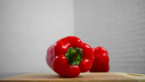Bell pepper falls on a bamboo cutting board Video stock 195523981