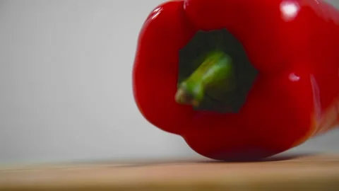Bell pepper falls on a bamboo cutting board Video stock 195523982