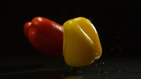 Bell pepper falls down on glass Stock Footage