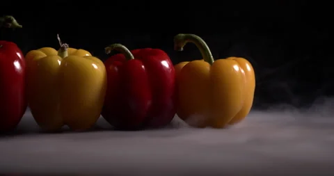 Bell pepper lies on a table on a black background Stock Footage 130360143