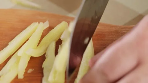 Bell Pepper Preparation: Close-up Slicing on Cutting Board Stock Footage 249422796