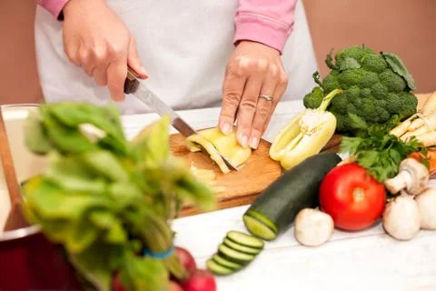Bell pepper sliced with a knife on cutting board Stock Photos