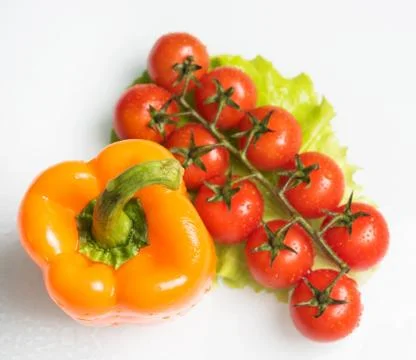 Bell pepper with a sprig of tomatoes Stock Photos
