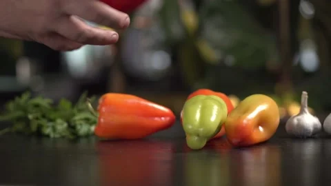 Bell pepper on the table. Chef hand takes red one Video stock 168839963