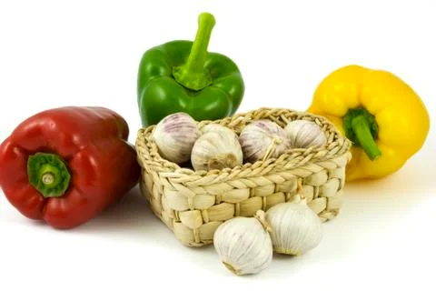 Bell peppers and basket with garlics Stock Photos