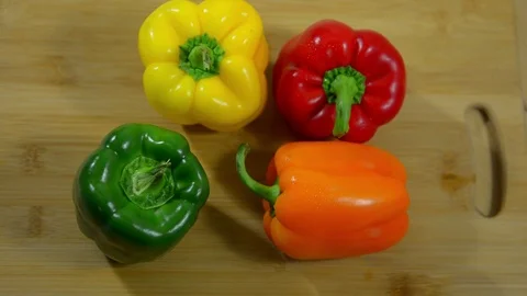 Bell peppers on the kitchen table, close-up. Red, Green, Yellow, Orange Peppers Stock-Footage 123347164