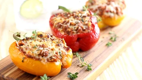 Bell Peppers stuffed with ground meat or vegetables, grated with parmesan cheese Stock Footage 104286403