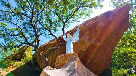 Bell Rock Along with a Statue - Backwards Shot Stock Footage 263323811