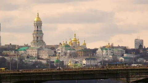 Bell tower and ancient cave monastery. Heavy traffic on the bridge Stock Footage 171620467
