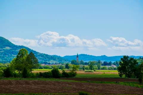 Bell tower and plowed fields Stock Photos