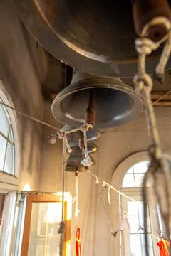 Bell tower with bells ringing during afternoon light inside a historic chur.. 写真素材