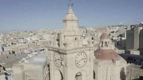 Bell tower clock and dome of church on background of old town Bormla Malta Stock Footage 130895864