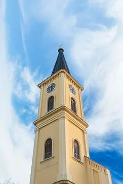 Bell tower with clock at Old town with cloudy sky Stock Photos