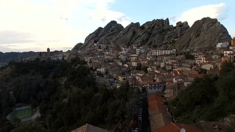 A bell tower in the foreground, behind a small southern Italian town Stock Footage 71634444