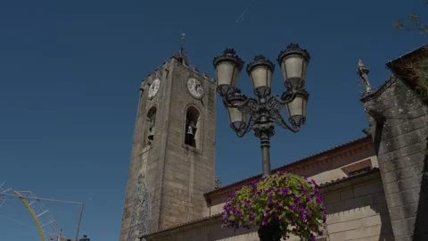 Bell tower of Igreja Matriz in Ponte de Lima against blue sky Stock Footage 346133555