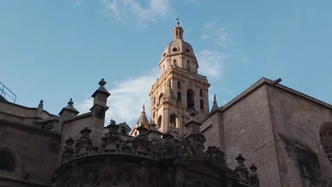 Bell Tower of Murcia Cathedral Under Clear Blue Sky at Sunset Stock Footage 333596783