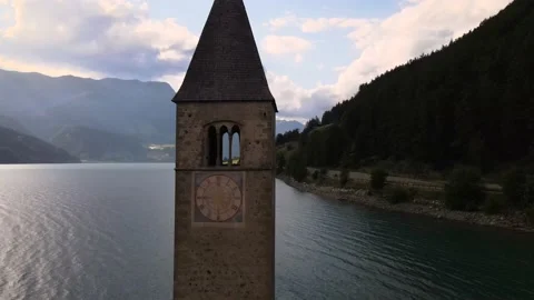 Bell tower that rises from the Resia lake in Curon Stock Footage