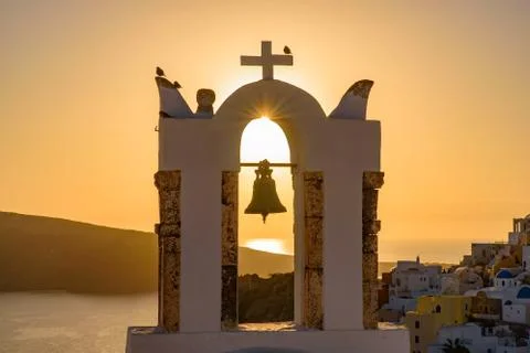 Bell tower with warm sunset light in Oia, Santorini, Greece Stock Photos