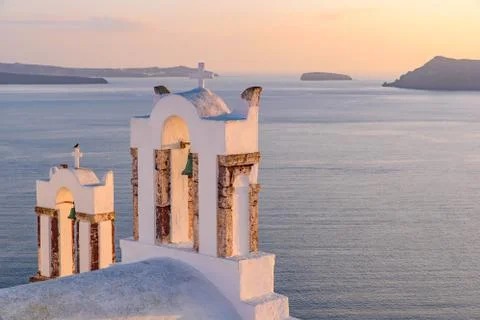 Bell tower with warm sunset light in Oia, Santorini, Greece Stock Photos
