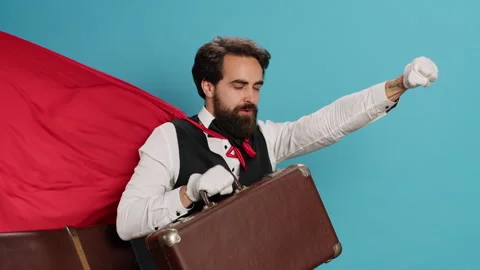 Bellhop acting as superhuman with cape Stock Footage 248563344