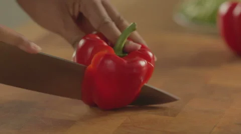 Bellpepper being cut in kitchen Stock-Footage 42142354