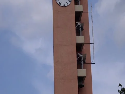 Bells Swinging on a Tower with City Clock Stock Footage 242673095