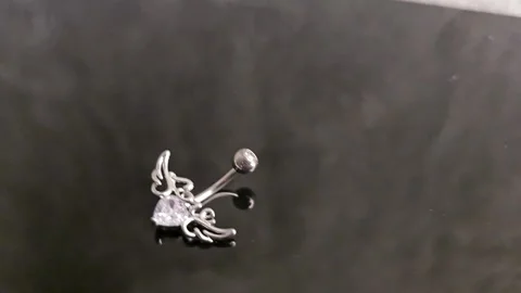 Belly button earrings with stones and a pendant in the shape Stock Footage 309186719