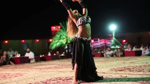 Belly dancer in action in desert of Dubai Stock Footage 130555688