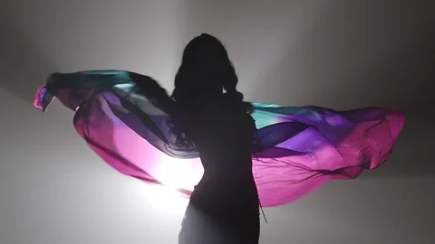 Belly dancer girl continue dance uses fans. Sihouette . Smoke background. Slow Video stock 105032324