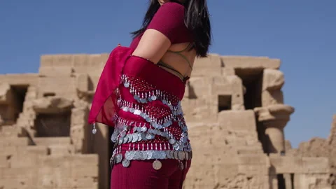 Belly dancer performing in front of ancient Egyptian ruins in Dendera, Egypt Stock Footage 309195780