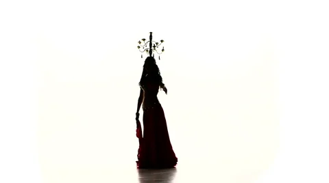 Belly dancer woman continue dance with burning candles on head, silhouette, slow Video stock 61094713