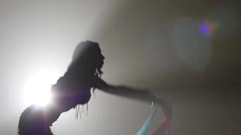 Belly dancer woman continue dance uses fans. Sihouette . Smoke background. Slow Video stock 105032350