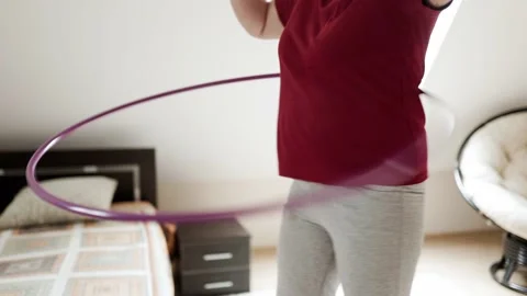 Belly exercise with hula hoop. Overweight female twirling hula hoop. Stock Footage 161745366