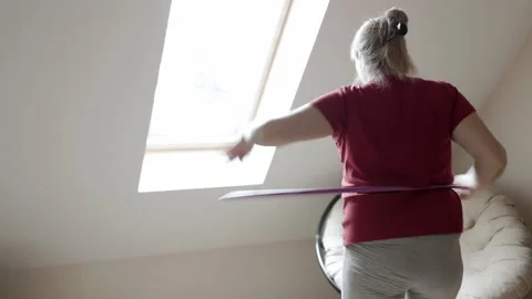 Belly exercise with hula hoop. Overweight female twirling hula hoop. Stock-Footage 161746044