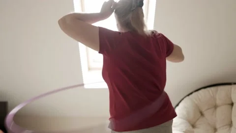 Belly exercise with hula hoop. Overweight female twirling hula hoop. Stock-Footage 161746096
