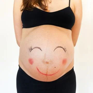 Belly with smiley face. Stock Photos
