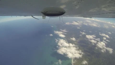Belly view of plane flying over sea Stock Footage 260578354