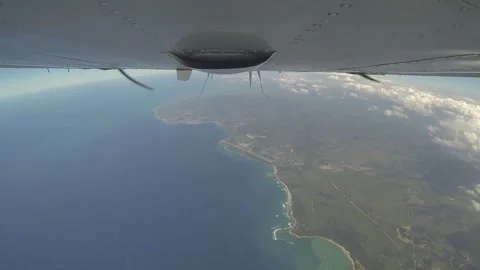 Belly view of plane flying over sea Stock Footage 260578356
