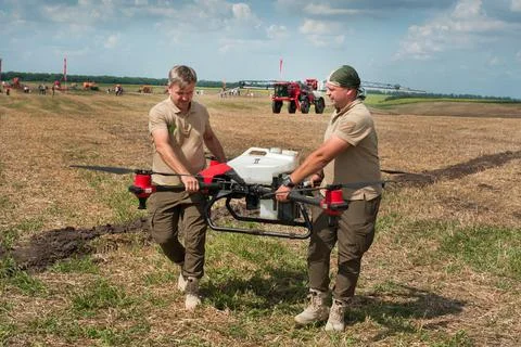Belogorye, Khmelnytsky region, UKRAINE - August 19, 2021: Two farmers carry a Stock Photos