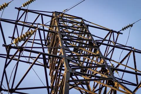 Below, a high voltage power line, black and white photo with selective focus. Stock Photos