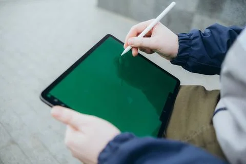 From below of hipster man using modern tablet with stylus while creating new Stock Photos