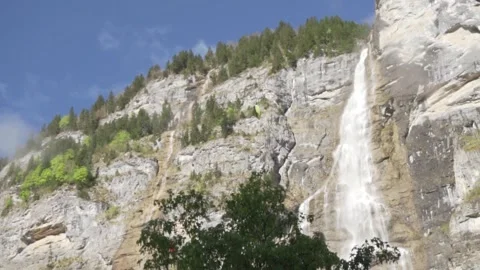 From below paraglides soar gracefully over rocky mountain during daytime Video stock 288930818