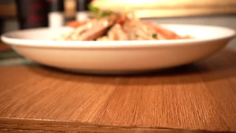 From below of risotto with jumbo shrimp on a white plate Stock Footage 129928026