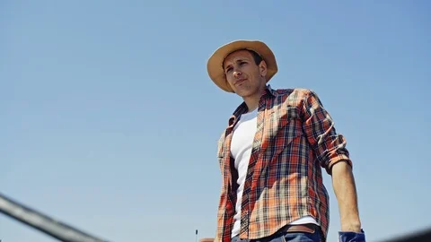 From below view of farmer loading lumber in truck on rural land with field on Stock Footage 97158276