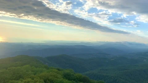 Below you can see the forest that grows on the mountains, above the sky, covered Stock Footage 201994935
