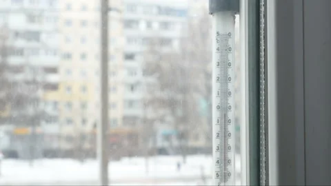 Below zero On window thermometer in city in snowfall, closeup, outdoors Stock Footage 149045679